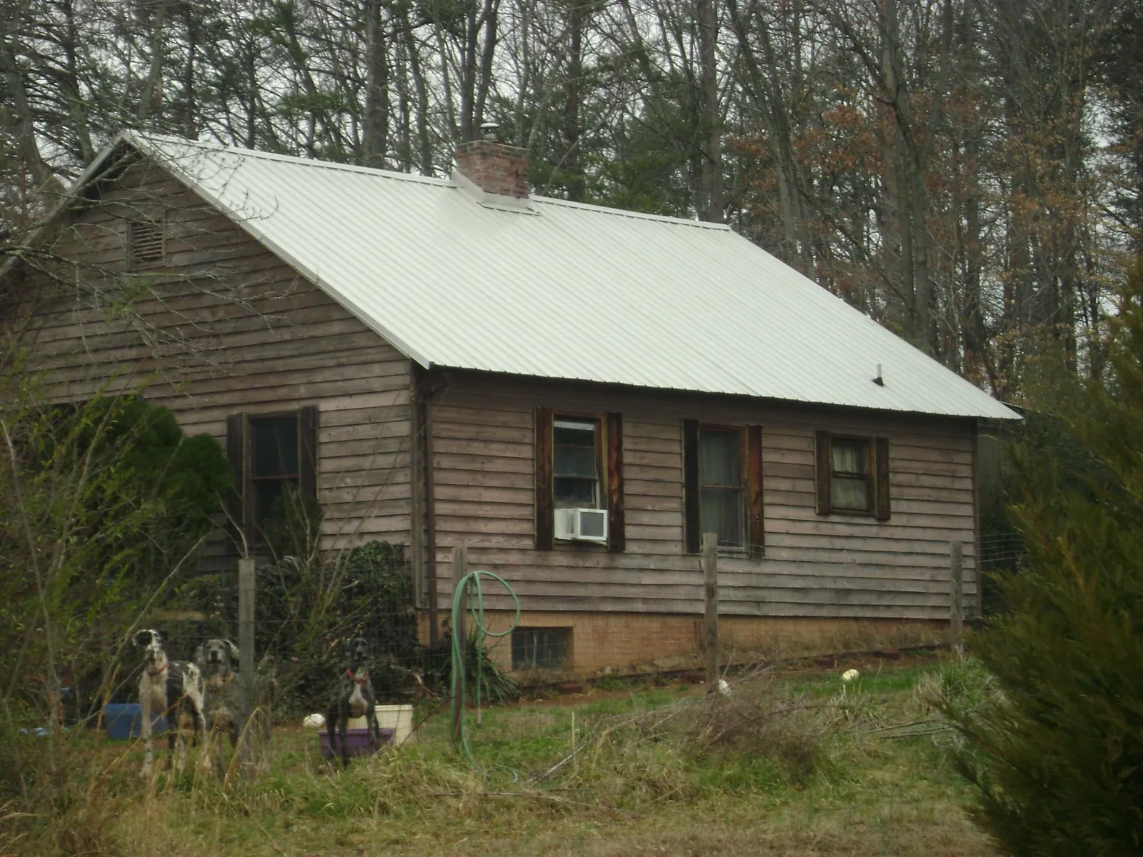White metal roof on an old wood sided farmhouse, from a Metal Roof Installation job in Concord
